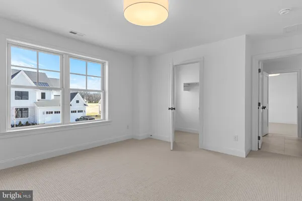 an empty room with windows and closet