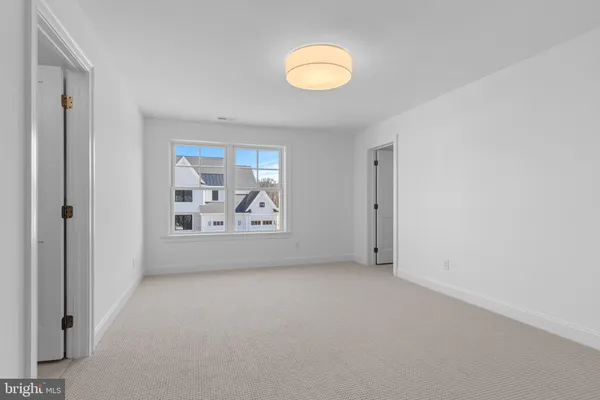 a view of a room with window and a ceiling fan
