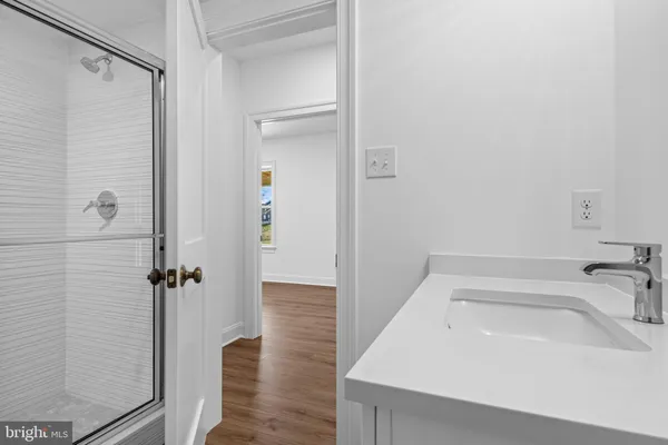a bathroom with a sink and shower