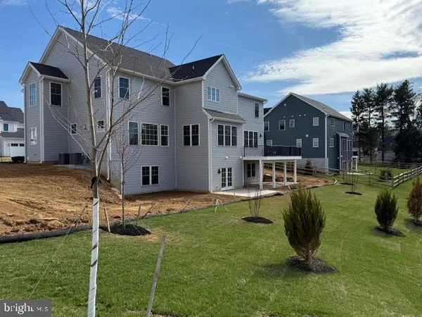 a front view of house with a garden and patio