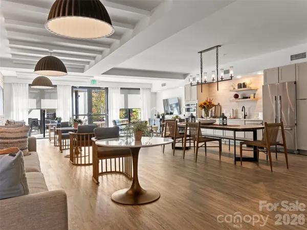 a view of a dining room with furniture and wooden floor