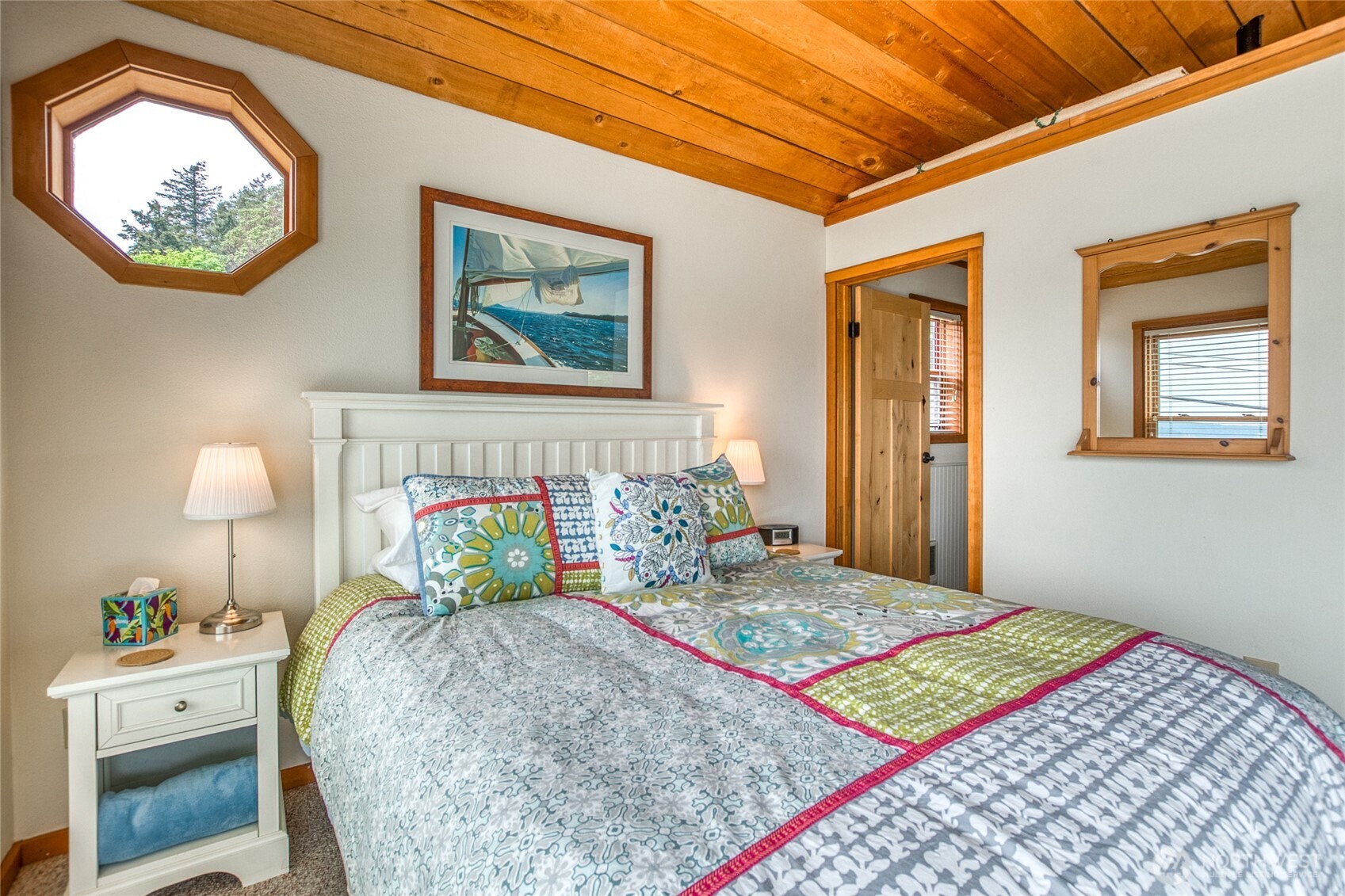942 Deer Harbor Road Orcas Island, WA 98245 - Photo 25 of 40 a bedroom with a bed and a lamp on dresser