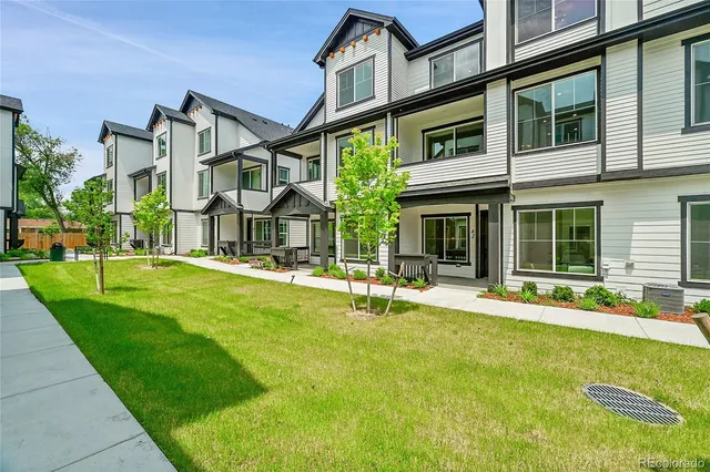 front view of a house with a yard and porch