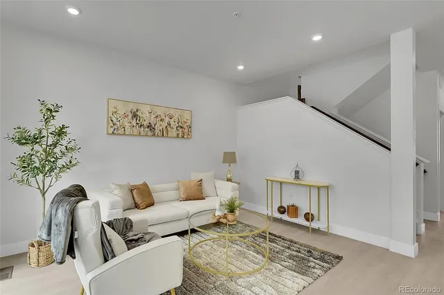 a living room with furniture and a rug