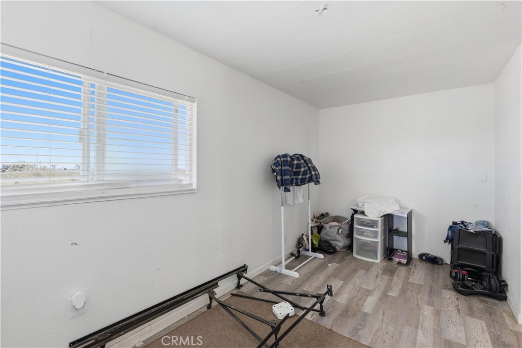 5885 Dos Palmas Road Phelan, CA 92371 - Photo 17 of 40 a view of a workspace with furniture and a window