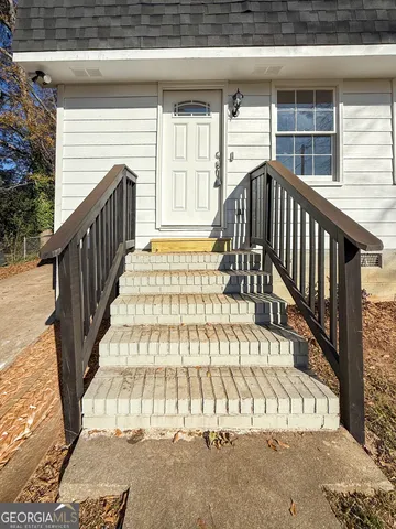 a view of entryway with wooden stairs