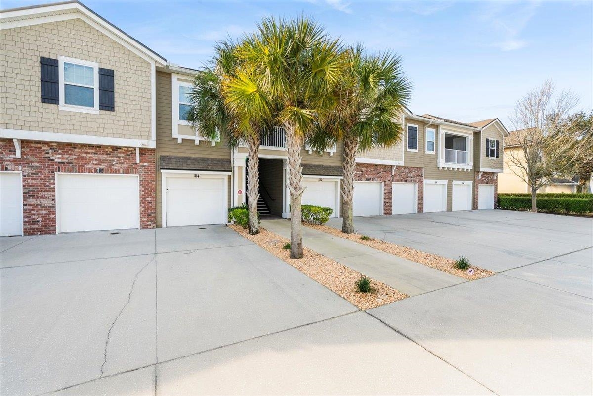 1112 Golden Lake Loop St. Augustine, FL 32084 - Photo 2 of 56 a front view of a house with a garden
