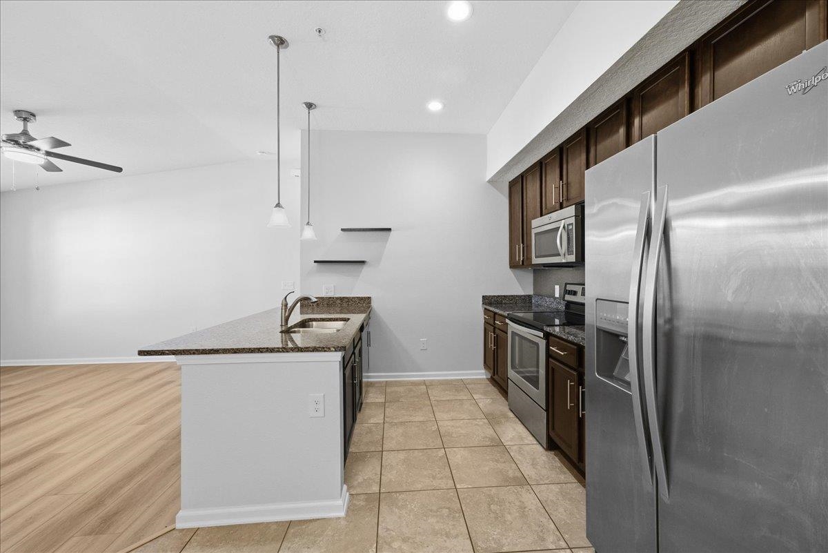 1112 Golden Lake Loop St. Augustine, FL 32084 - Photo 22 of 56 a kitchen with stainless steel appliances granite countertop a refrigerator a stove and a sink