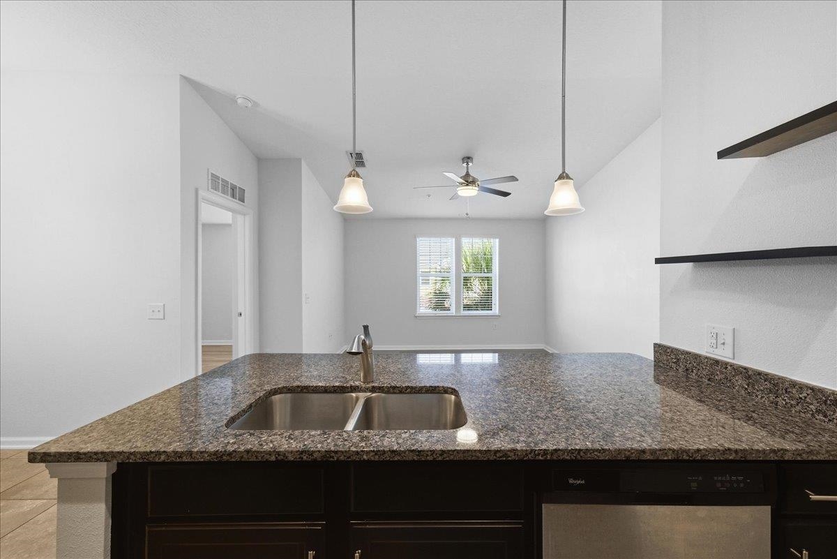 1112 Golden Lake Loop St. Augustine, FL 32084 - Photo 24 of 56 a kitchen with granite countertop a sink a counter top space and cabinets