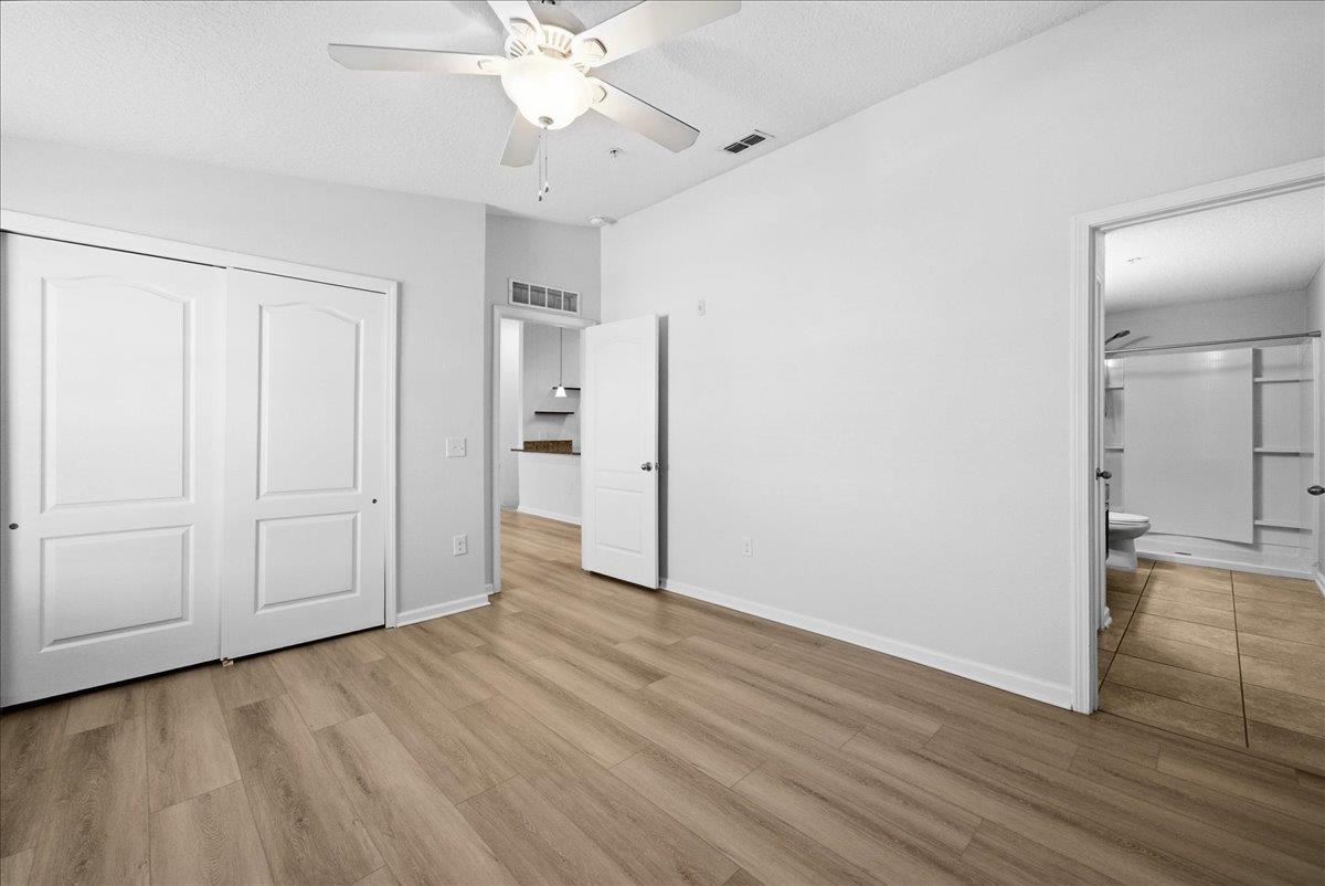 1112 Golden Lake Loop St. Augustine, FL 32084 - Photo 25 of 56 an empty room with wooden floor cabinet and windows