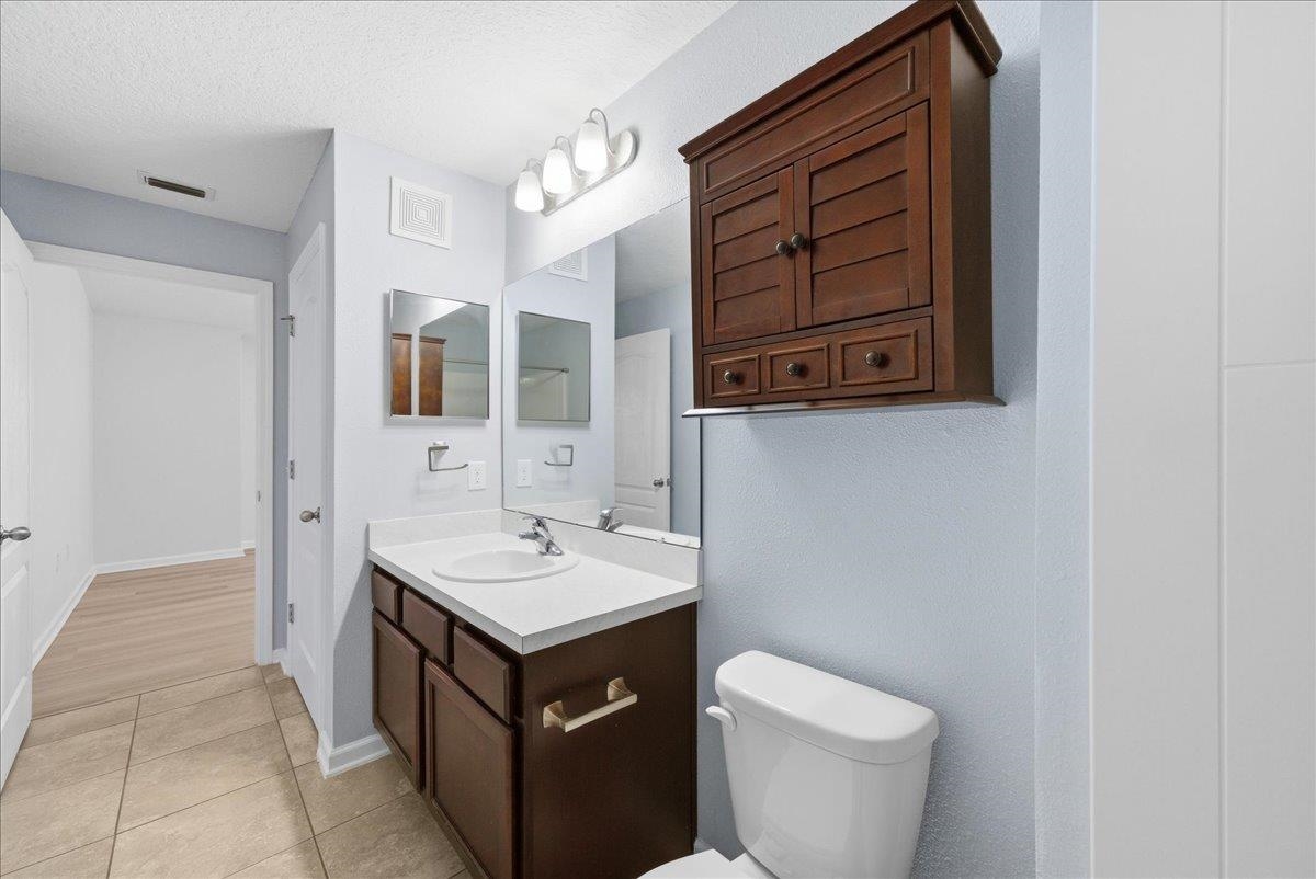 1112 Golden Lake Loop St. Augustine, FL 32084 - Photo 27 of 56 a bathroom with a sink a toilet and a mirror