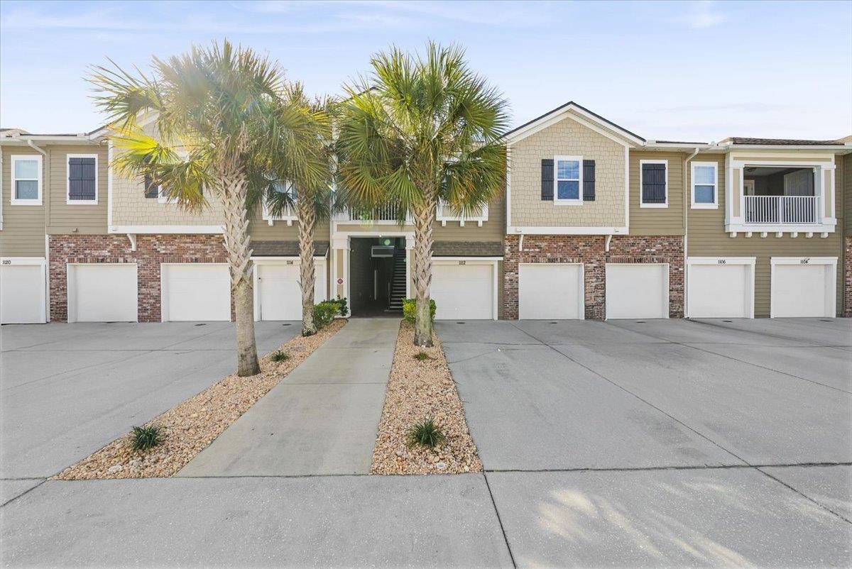 1112 Golden Lake Loop St. Augustine, FL 32084 - Photo 3 of 56 a front view of a house with a yard and garage