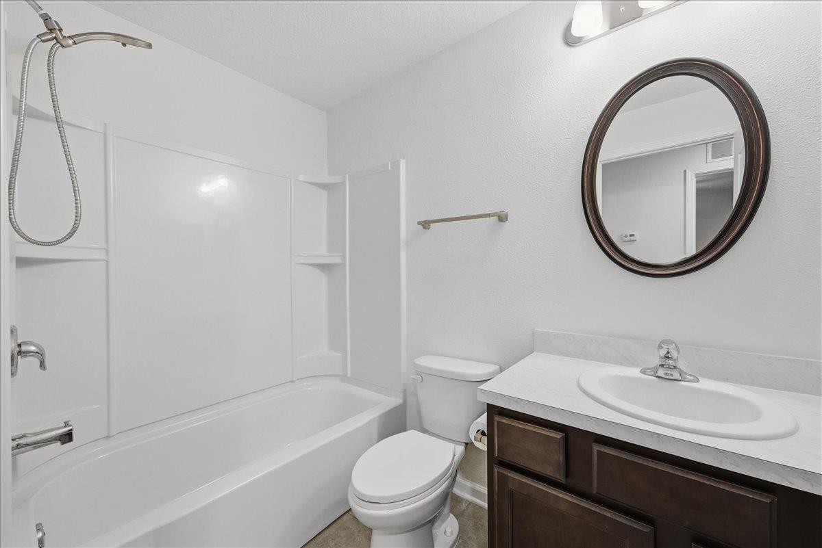 1112 Golden Lake Loop St. Augustine, FL 32084 - Photo 31 of 56 a bathroom with a sink a toilet and a mirror