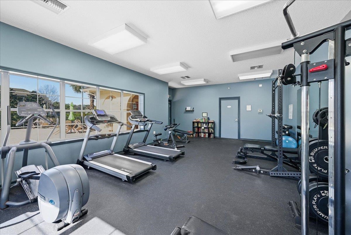 1112 Golden Lake Loop St. Augustine, FL 32084 - Photo 56 of 56 a living room with furniture gym equipment and a large window