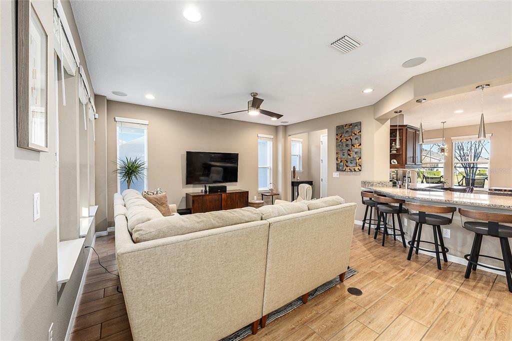 5589 Northwest 40th Loop Ocala, FL 34482 - Photo 11 of 47 a living room with furniture a flat screen tv and a table