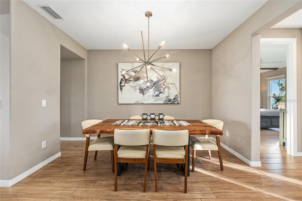 5589 Northwest 40th Loop Ocala, FL 34482 - Photo 12 of 47 a view of a dining room with furniture window and wooden floor
