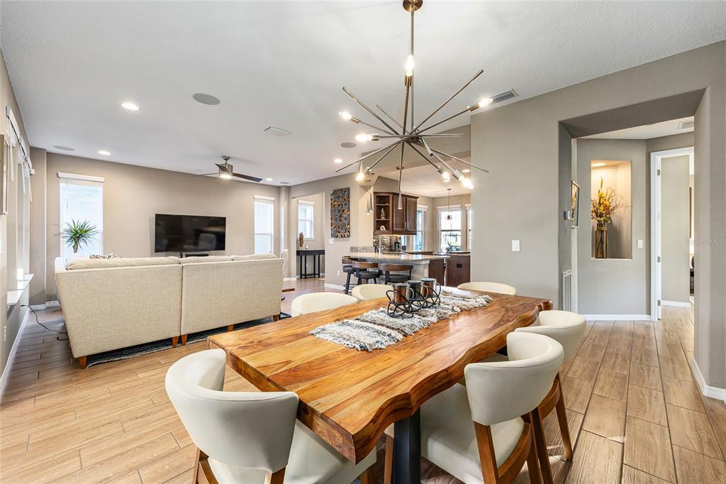 5589 Northwest 40th Loop Ocala, FL 34482 - Photo 14 of 47 a view of a dining room with furniture window and wooden floor