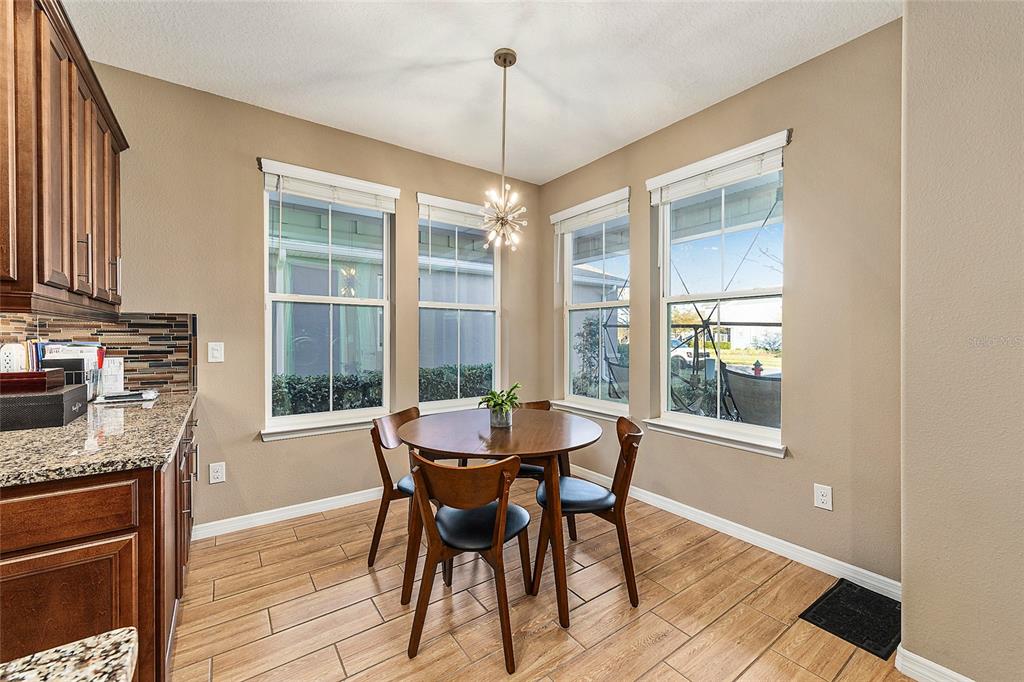 5589 Northwest 40th Loop Ocala, FL 34482 - Photo 19 of 47 a dining room with furniture a chandelier and wooden floor