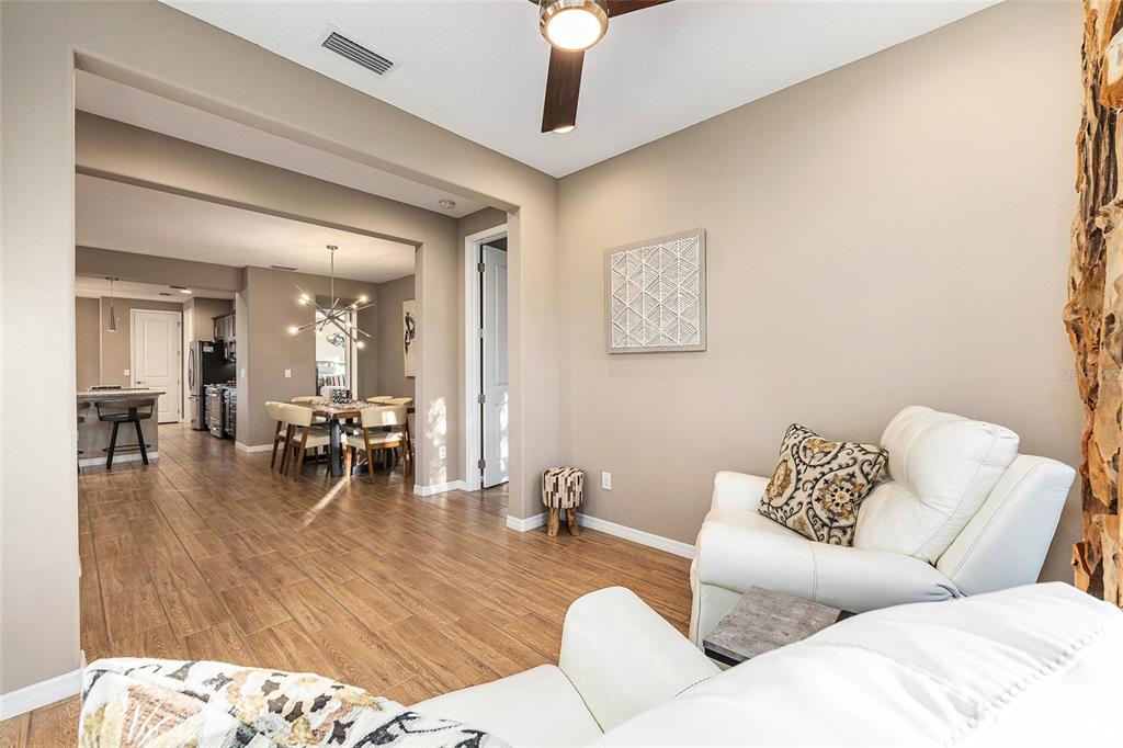 5589 Northwest 40th Loop Ocala, FL 34482 - Photo 23 of 47 a living room with furniture and wooden floor