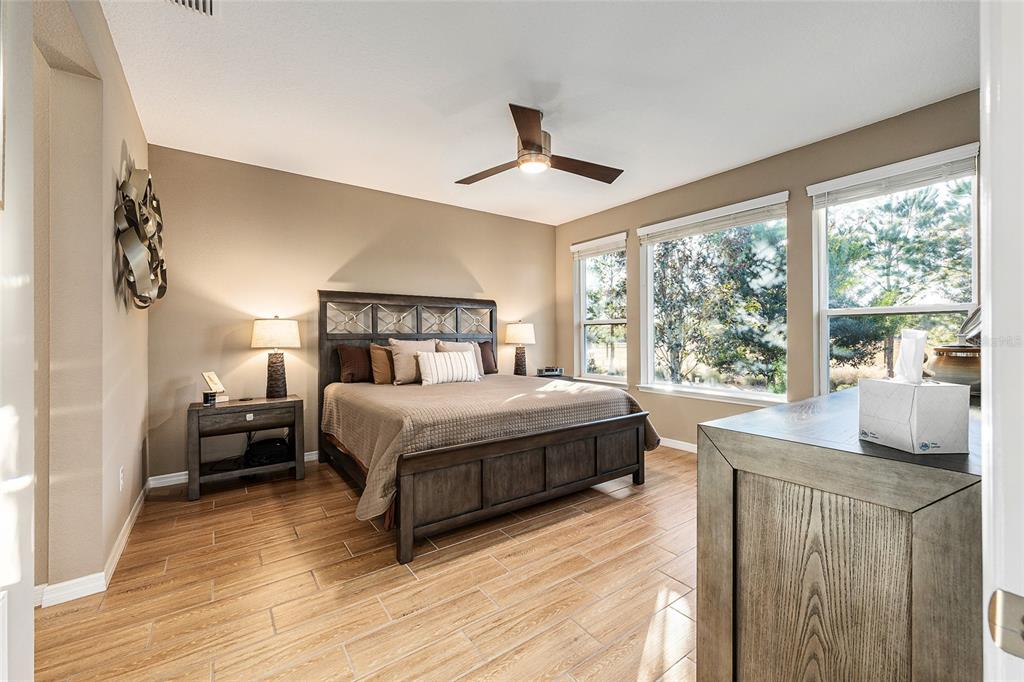 5589 Northwest 40th Loop Ocala, FL 34482 - Photo 24 of 47 a bedroom with a large bed and a large window