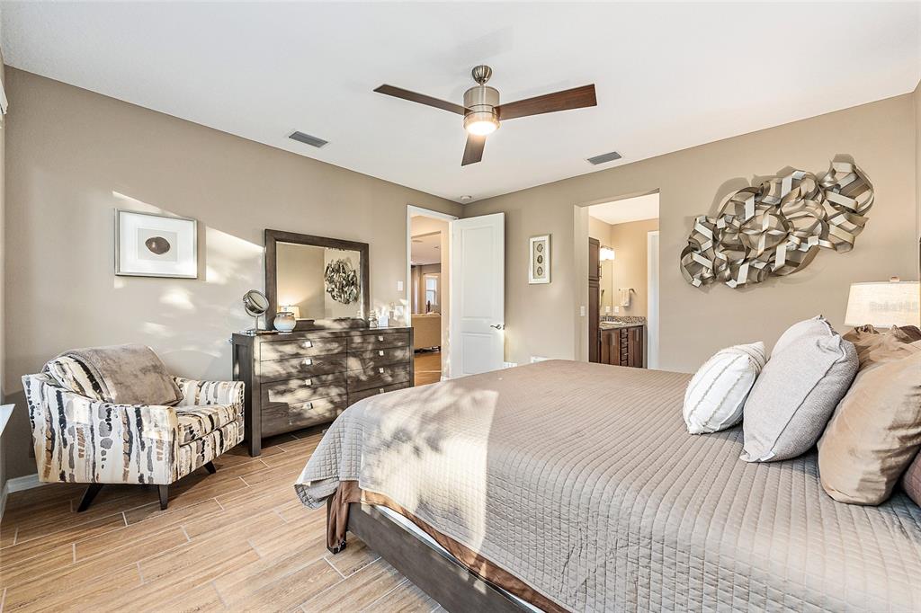 5589 Northwest 40th Loop Ocala, FL 34482 - Photo 25 of 47 a spacious bedroom with a bed and couch