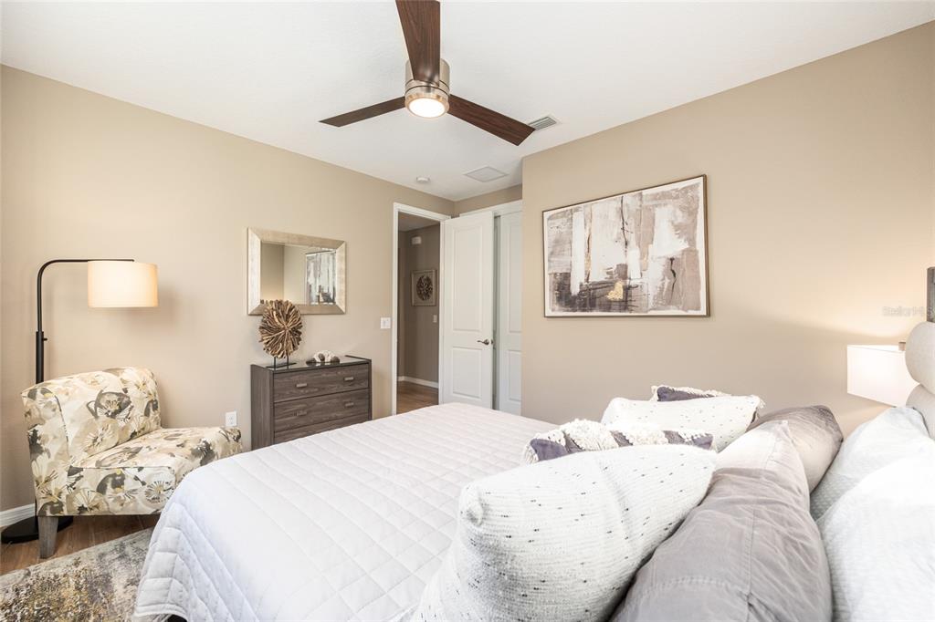 5589 Northwest 40th Loop Ocala, FL 34482 - Photo 32 of 47 a bedroom with a bed and wooden floor