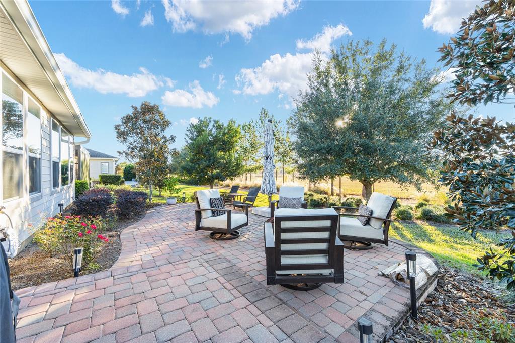 5589 Northwest 40th Loop Ocala, FL 34482 - Photo 37 of 47 a view of a patio with table and chairs and potted plants