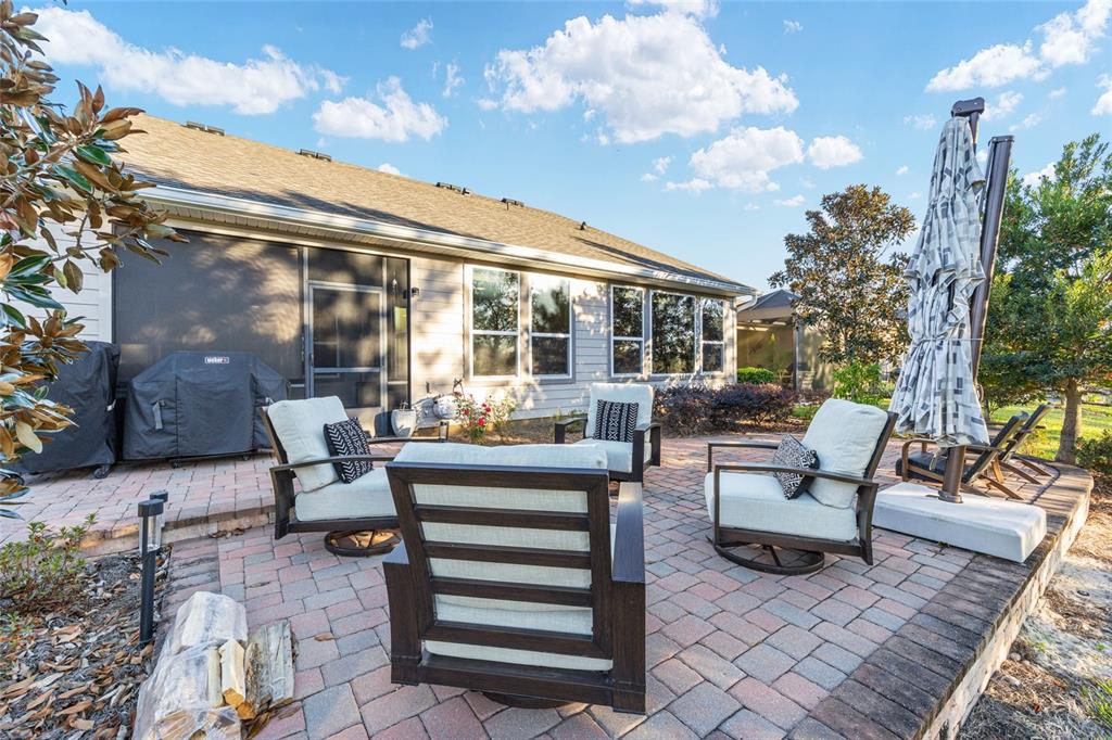5589 Northwest 40th Loop Ocala, FL 34482 - Photo 40 of 47 a view of a patio with couches and table and chairs and potted plants