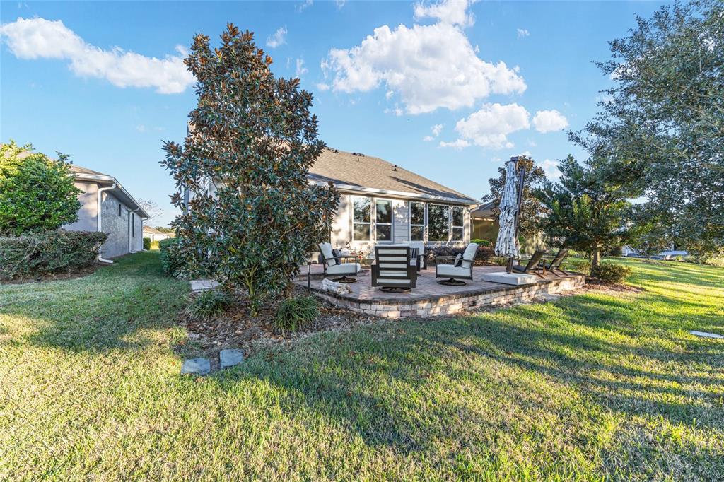 5589 Northwest 40th Loop Ocala, FL 34482 - Photo 41 of 47 a view of a house with backyard sitting area and garden