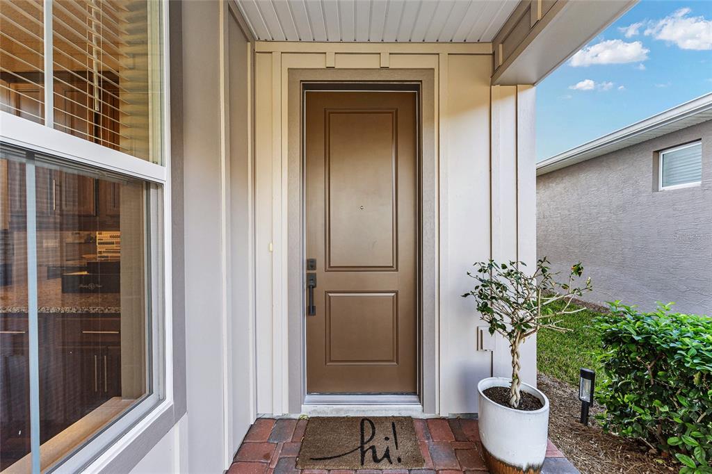 5589 Northwest 40th Loop Ocala, FL 34482 - Photo 6 of 47 a potted plant sitting in front of a door