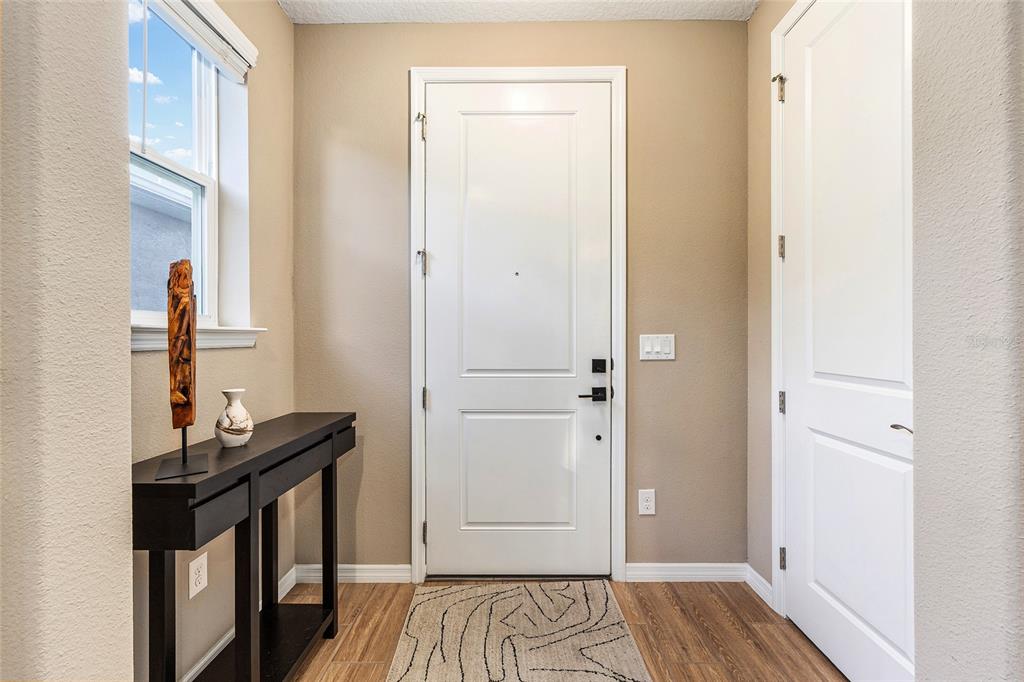 5589 Northwest 40th Loop Ocala, FL 34482 - Photo 8 of 47 a view of a livingroom with wooden floor and a flat screen tv