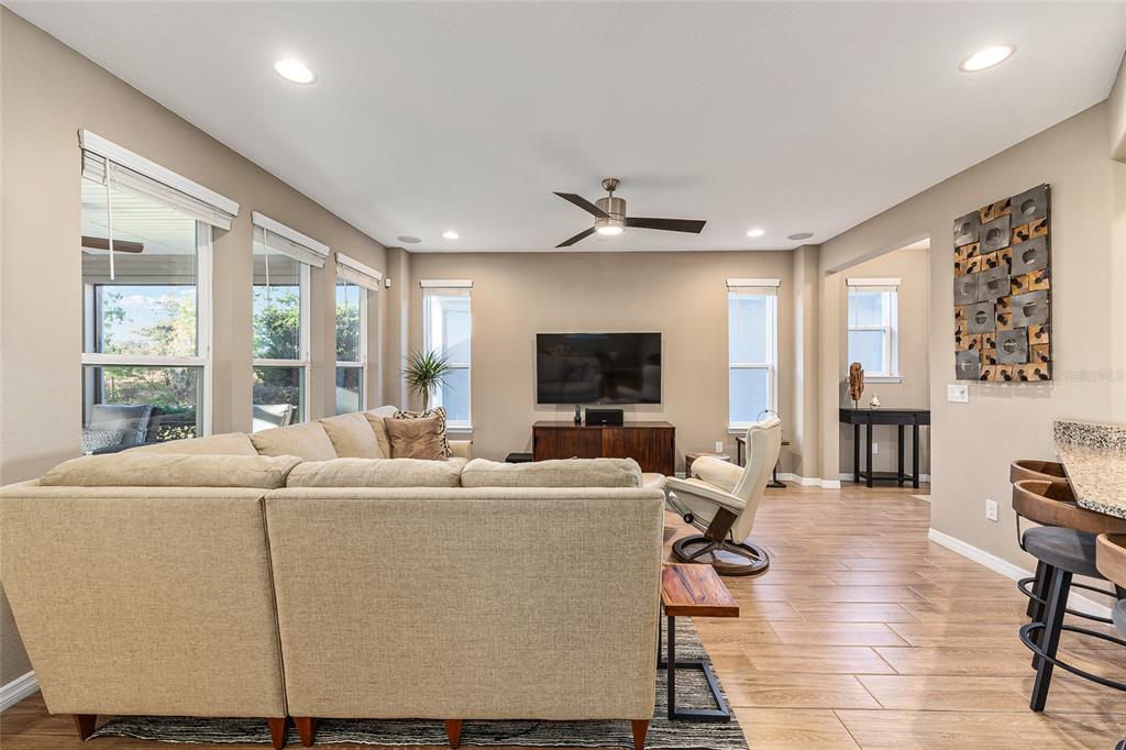5589 Northwest 40th Loop Ocala, FL 34482 - Photo 10 of 47 a living room with furniture a flat screen tv and a large window