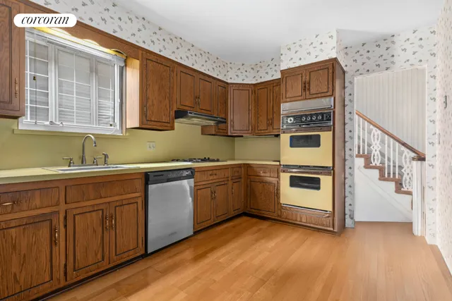 an empty room with windows and fireplace