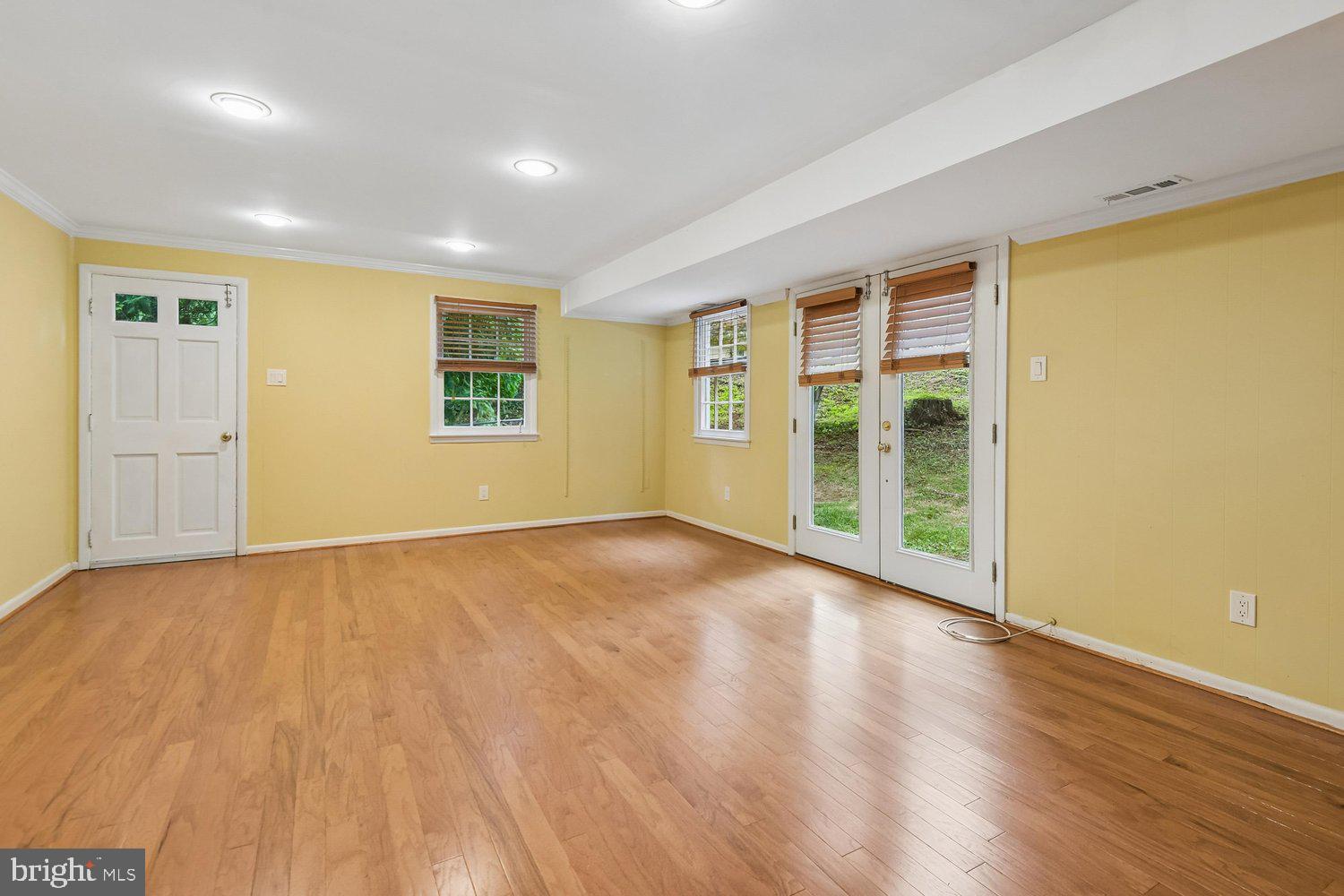 1518 Winchester Road Annapolis, MD 21409 - Photo 21 of 70 a view of an empty room with wooden floor and a window