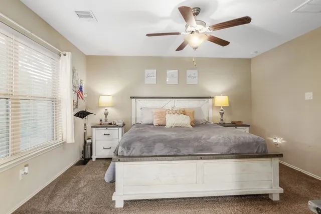 a bedroom with a bed and window