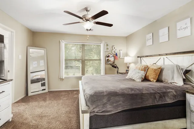 a bedroom with a large bed and a window