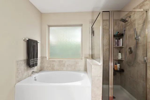 a bathroom with a bathtub and a shower