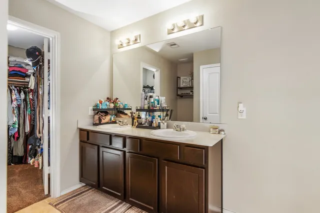 a bathroom with a sink vanity and mirror