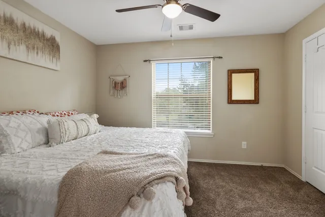 a bedroom with a bed and a window