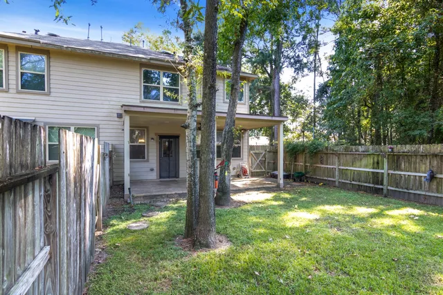 a view of a backyard with a small cabin and a chair