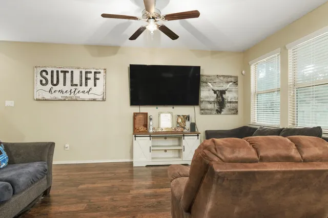 a living room with furniture and a flat screen tv