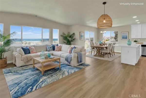 a living room with furniture dining table and a large window