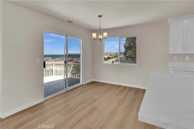 wooden floor fireplace and windows in an empty room