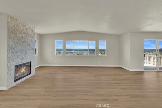 a view of a small space with wooden floor and a window