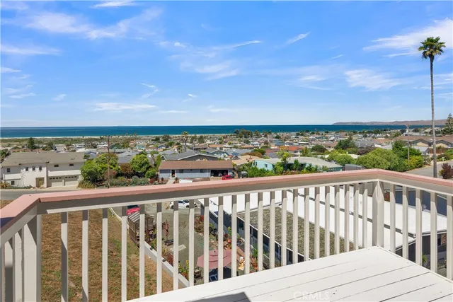a kitchen with a sink a stove a refrigerator and white cabinets