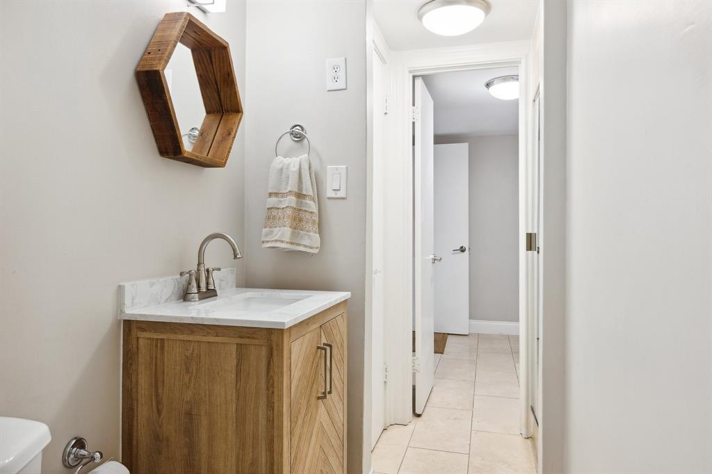 6160 Spring Valley Road Dallas, TX 75240 - Photo 16 of 40 a bathroom with a sink and a mirror