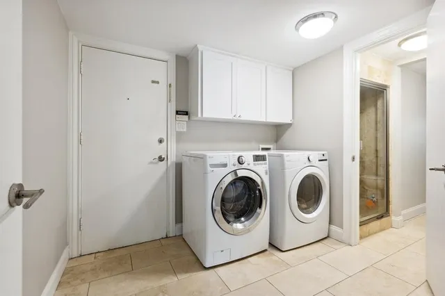 a living room with furniture a chandelier and a large window