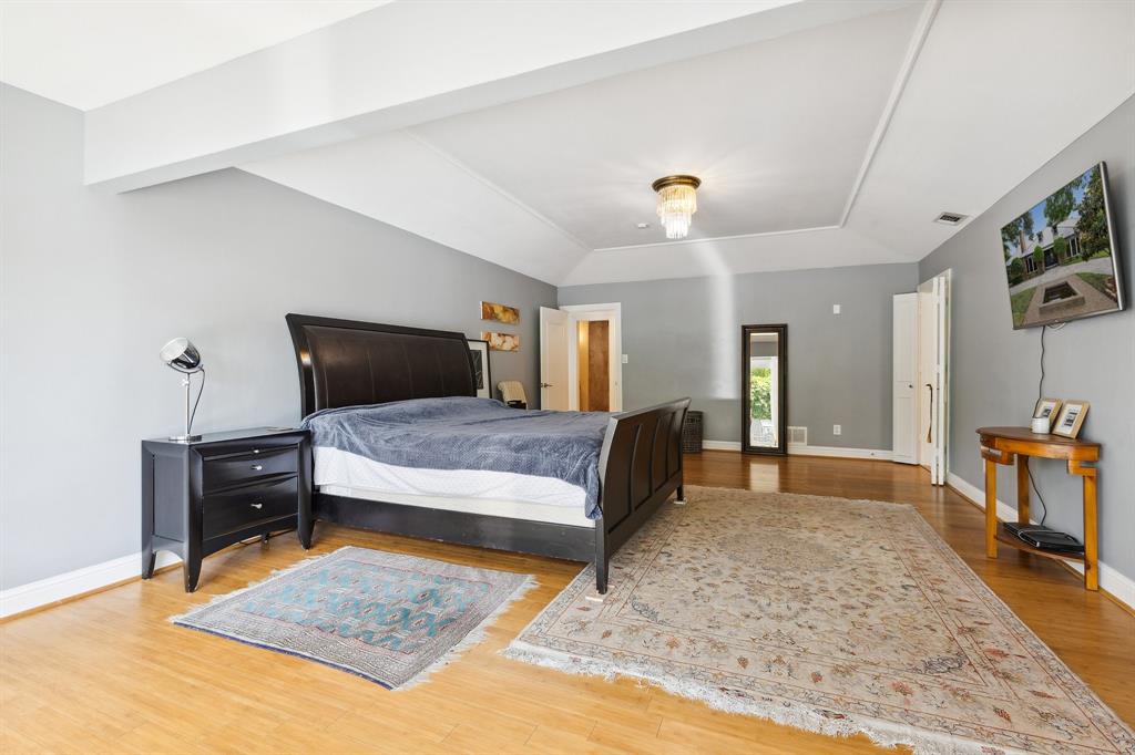 6160 Spring Valley Road Dallas, TX 75240 - Photo 26 of 40 a bedroom with a bed and a dresser in it