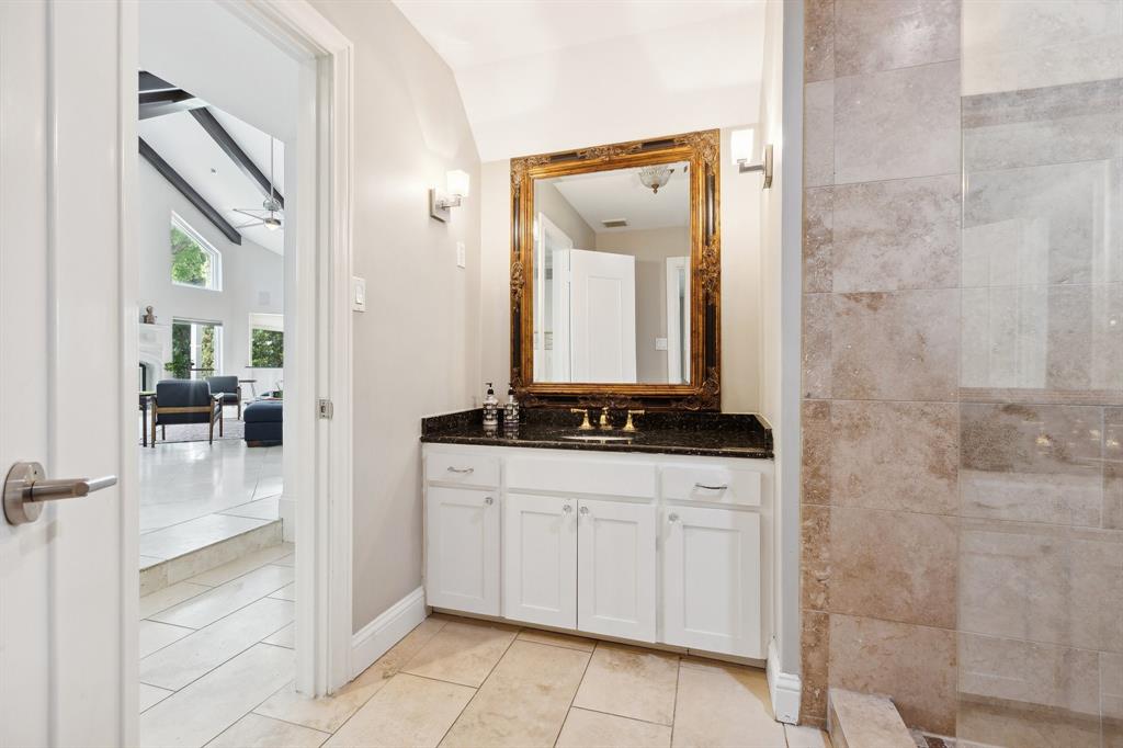 6160 Spring Valley Road Dallas, TX 75240 - Photo 27 of 40 a bathroom with a granite countertop sink a mirror and a shower