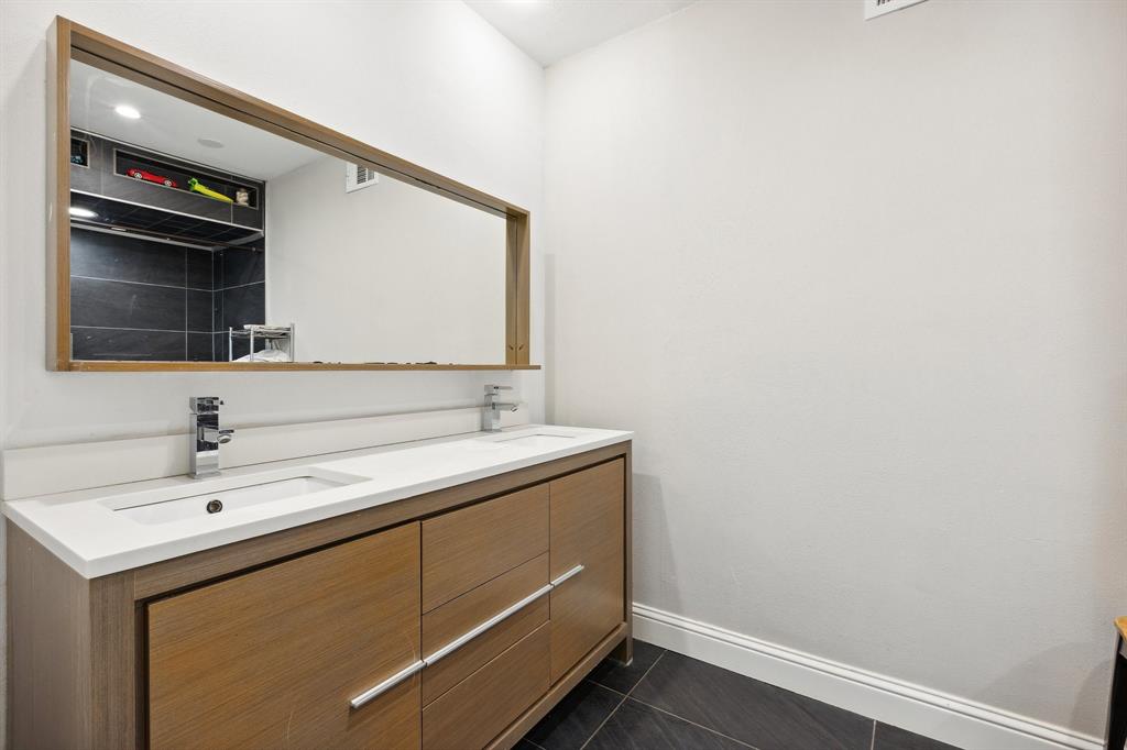 6160 Spring Valley Road Dallas, TX 75240 - Photo 29 of 40 a bathroom with a sink and a mirror